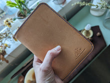 Load image into Gallery viewer, A unique luxury handmade leather passport holder made in Vancouver. It can hold up to four passports, boarding passes and payment cards. Perfect for a solo or a parent traveller.

