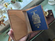 Load image into Gallery viewer, A unique luxury handmade leather passport holder made in Vancouver. It can hold up to four passports, boarding passes and payment cards. Perfect for a solo or a parent traveller.
